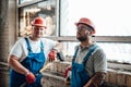 Two tired workers standing near the window at a construction site Royalty Free Stock Photo