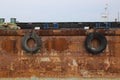 Close up tires on the rusted ship in the harbor Royalty Free Stock Photo