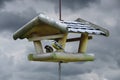 Two tits taking nuts from bird feeder Royalty Free Stock Photo