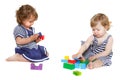 Two toddler girls playing with building blocks Royalty Free Stock Photo