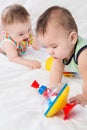 Two toddler playing with a toy whirligig on the