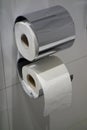 two toilet paper on a hotel bathroom wall Royalty Free Stock Photo