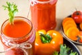 Two tomato smoothies in a glass jar with the ingredients for its preparation. Fresh tomatoes, carrots, bell peppers and lettuce on Royalty Free Stock Photo