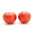 Two tomatoes with googly eyes isolated on white Royalty Free Stock Photo