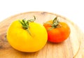 Two tomatoes on wooden cutting board Royalty Free Stock Photo