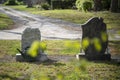 Two tombstones on a grave yard, backview, focus on stones Royalty Free Stock Photo