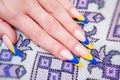 Two tone manicure with blue and yellow varnish Royalty Free Stock Photo