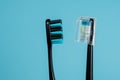 Two toothbrushes on a blue background