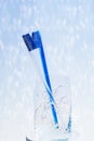 Toothbrushes kiss in a glass on the background of hearts