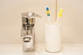 Two toothbrushes in the white box and mixer tap Royalty Free Stock Photo