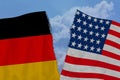 Two torn flags america and Germany, the concept of bad international relations, diplomatic conflict, global world trade, politics Royalty Free Stock Photo