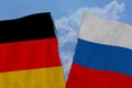 Two torn flags of Russia and Germany, the concept of bad international relations, diplomatic conflict, trade, business Royalty Free Stock Photo