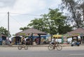 Two tourist girls riding bicycles on the street in Sri Lanka