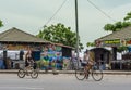 Two tourist girls riding bicycles on the street