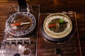 Two magnetic compasses on wooden table Royalty Free Stock Photo