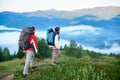 Two tourists with backpacks in hike on mountains of Carpathians Royalty Free Stock Photo