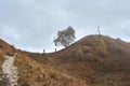 Two tourists climb the path to the top of the mountain. Royalty Free Stock Photo