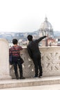 Two tourists couple in Rome. Man pointing dome church.