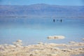 Two tourists floating in the Dead Sea water