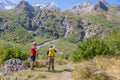 Two tourists are going to climb up the mountain to the waterfalls, inspect the area. Royalty Free Stock Photo