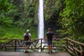 Two tourists looking at the La Fortuna Waterfall in Costa Rica