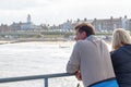 Two tourists looking over the beautiful view of Southwold from the pier