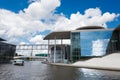 Two tourists ships floats on the river Spree next to a modern buildings of Bundestag and Marie-Luders-Haus. Berlin - Germany