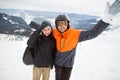 Two tourists skier on top of the mountain wearing a helmet, hap Royalty Free Stock Photo
