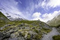 Two tourists stand on the hillside to take panoramic pictures of the Mueller Glacier Royalty Free Stock Photo