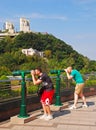 Two tourists using a pair of Green Tourist panoramic telescope at the Peak, Hong Kong Royalty Free Stock Photo