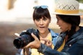 two tourists watching photos from dslr camera Royalty Free Stock Photo
