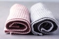 Two Towels Tolled Up on a Gray Background Pink and Gray Towels Close up Horizontal