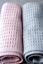 Two Towels Tolled Up on a Gray Background Pink and Gray Towels Close up Vertical