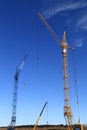 Two tower cranes and a truck crane at a construction site Royalty Free Stock Photo