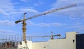 Two tower cranes are working on the construction of a large building. Industrial background Royalty Free Stock Photo