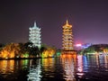 Two towers locate in the middle of lake in the night