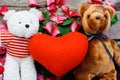 Two Toy bear doll have falling in love with Rose petals background .