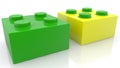 Two toy bricks in green and yellow colors Royalty Free Stock Photo