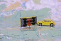 Two toy cars collided on the geographical map of the world. Accident of several cars. Crash on the road. Selective focus