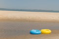 Two toy life preservers lying on the beach Royalty Free Stock Photo