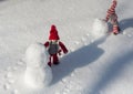 Two toy little men playing in the snow Royalty Free Stock Photo