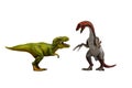 Two toy predator dinosaurs fighting on white background