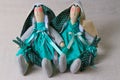 Two toy rabbits in green dresses, easter