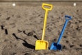 Two toy shovels in the sandbox Royalty Free Stock Photo