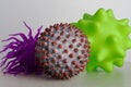 Two toys as a representation of virus or bacterias and one as a symbol of a SARS-CoV-2 virion