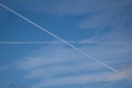 Two traces from planes crossing in the sky blue sky with some thin clouds Royalty Free Stock Photo