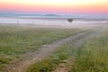 A two track dirt farm road in the early morning mist in the county side of South Africa,