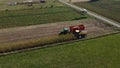 Two tractors harvesting corn in a field