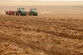 Two tractors pulling potato harvestors through the farm fields of Idaho. Royalty Free Stock Photo