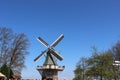 Two traditional Dutch windmills with tulips rows at spring day, Netherlands Royalty Free Stock Photo